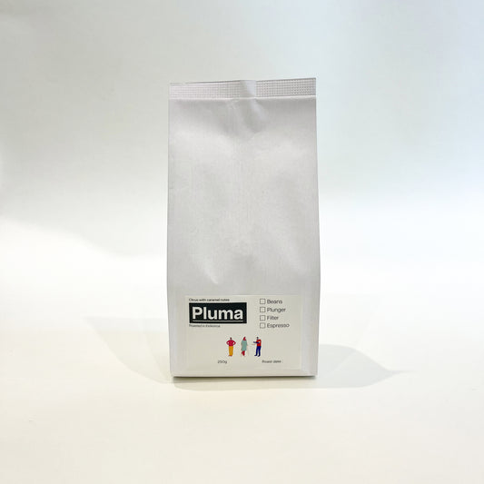 A white bag of TLF Pluma coffee with a green label.