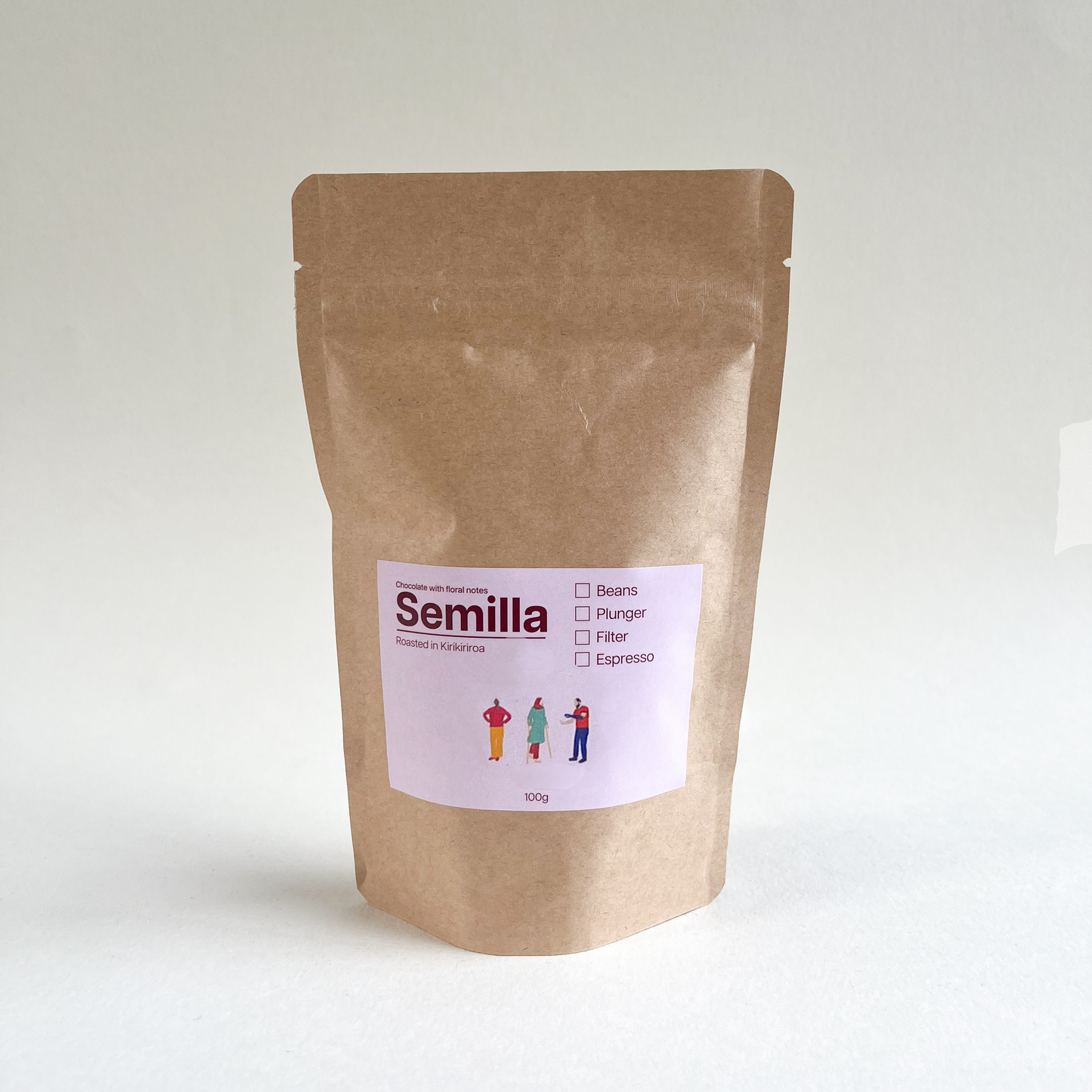 A kraft bag of TLF Semilla coffee with pink label